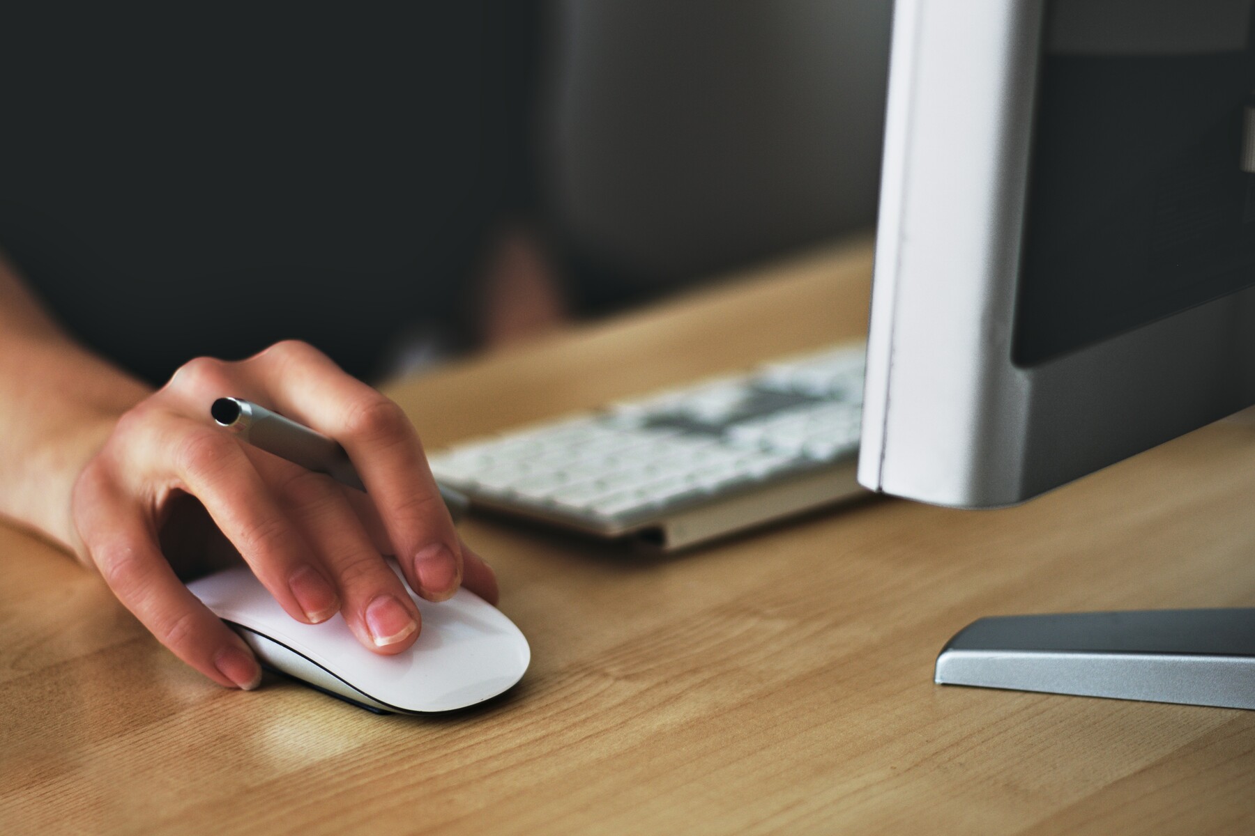 hand moving mouse at computer