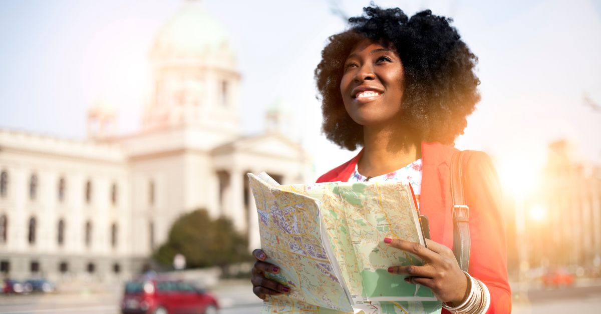 a woman holding a map and looking up